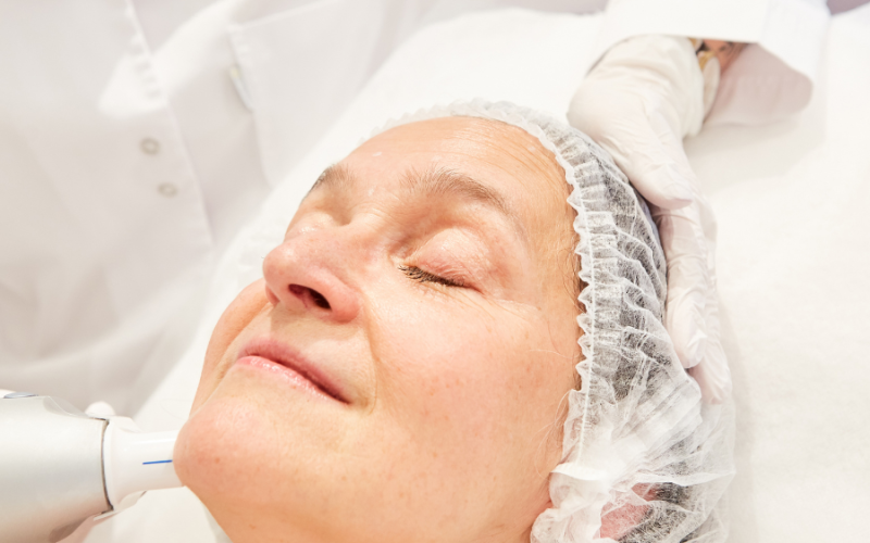 A woman getting private cancer thriver treatments for her skin