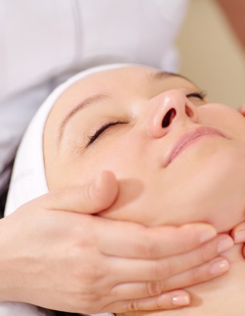 a woman receiving a bespoke facial at a skin clinic